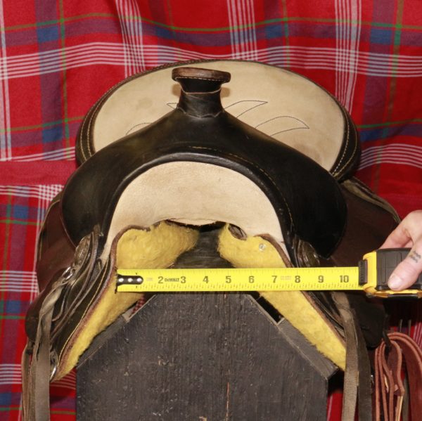 Front view of saddle with tape measure, reading 8" wide