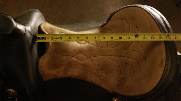 Seat of saddle, with tape measure, reading 14 inches at the seat